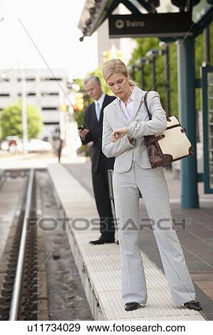Two business people at a train station View Large Photo Image Stock Photo - Two business people at a train station. Fotosearch