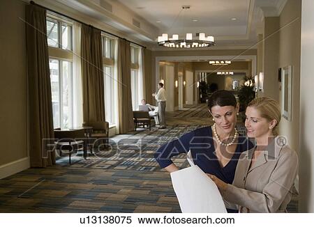 Two business people in a lobby View Large Photo Image Stock Photography - Two business people in a lobby. Fotosearch