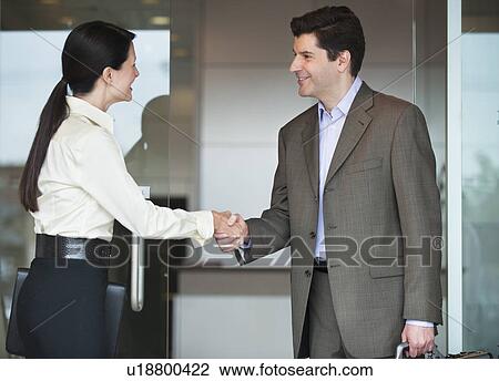 Two business people shaking hands View Large Photo Image Stock Image - Two business people shaking hands. Fotosearch