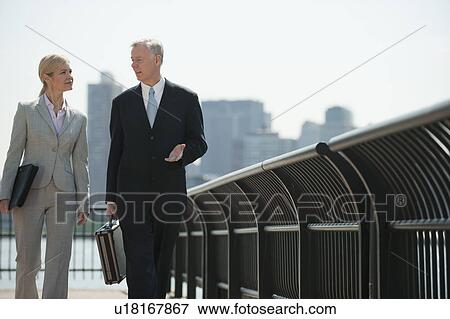 Stock Photo - Two business people walking outdoors. Fotosearch
