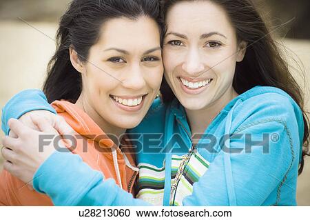 Two girl friends at the beach View Large Photo Image Stock Image - Two girl friends at the beach. Fotosearch