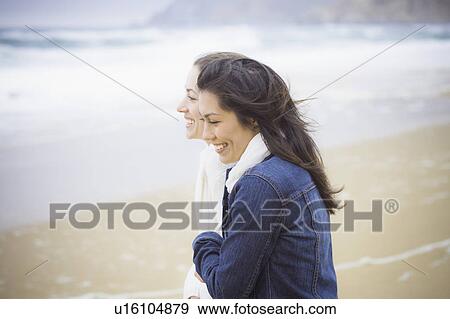 Stock Photo - Two girl friends at the beach. Fotosearch