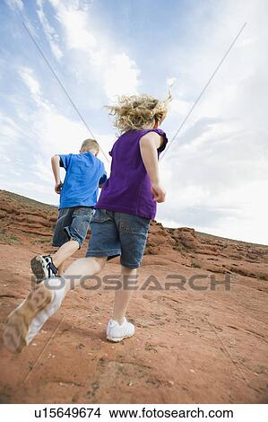 Two kids running at Red Rock View Large Photo Image Picture - Two kids running at Red Rock. Fotosearch