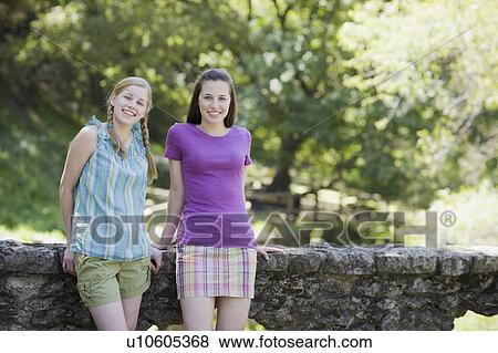 Two sisters outdoors View Large Photo Image Stock Photo - Two sisters outdoors. Fotosearch