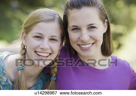 Two sisters outdoors View Large Photo Image Stock Photo - Two sisters outdoors. Fotosearch