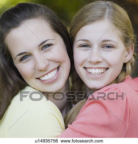 Two sisters outdoors View Large Photo Image Stock Photograph - Two sisters outdoors. Fotosearch