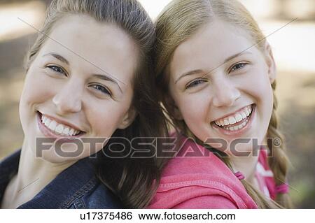 Two sisters outdoors View Large Photo Image Stock Photograph - Two sisters outdoors. Fotosearch