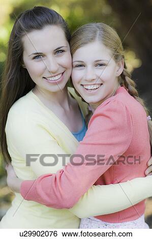 Two sisters outdoors View Large Photo Image Stock Photograph - Two sisters outdoors. Fotosearch