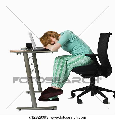 Stock Image - Woman asleep at a computer. Fotosearch