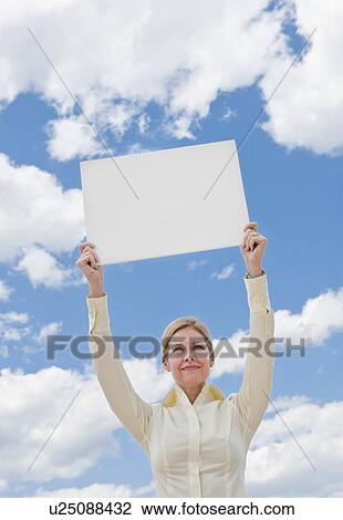 Woman holding a blank sign View Large Photo Image Stock Image - Woman holding a blank sign. Fotosearch