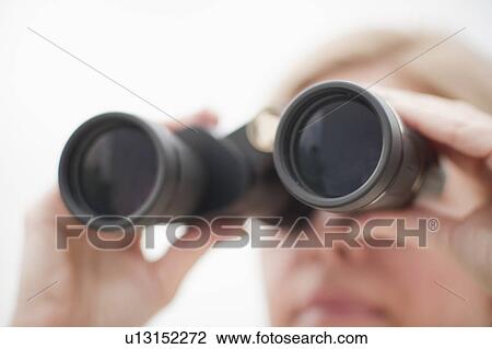 Stock Image - Woman using binoculars. Fotosearch