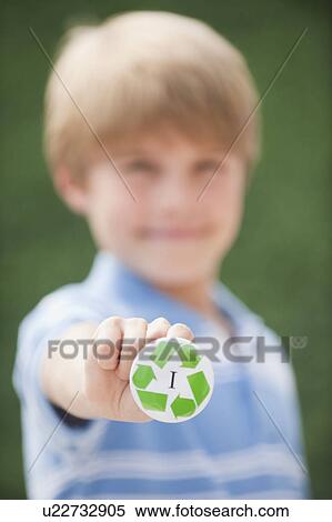Young boy holding recycling button View Large Photo Image Stock Photography - Young boy holding recycling button. Fotosearch