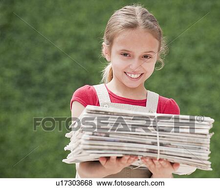 Young girl with stack of newspapers View Large Photo Image Stock Photo - Young girl with stack of newspapers. Fotosearch