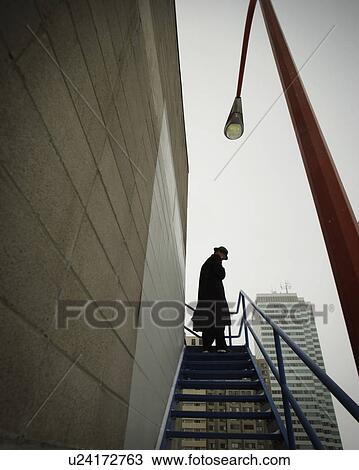 A businessman ascending a stairway View Large Photo Image Stock Image - A businessman ascending a stairway. Fotosearch