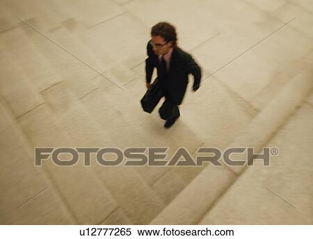 A businessman walks quickly View Large Photo Image Stock Photography - A businessman walks quickly. Fotosearch