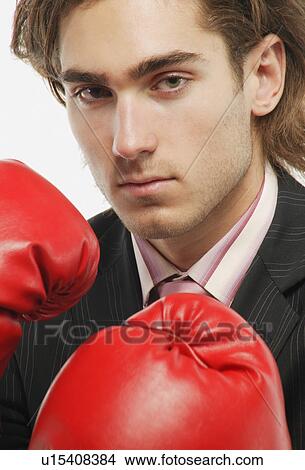 Picture - A businessman with boxing gloves. Fotosearch