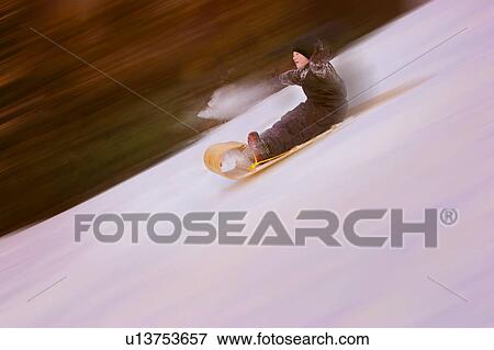 Stock Photo - A child sledging. Fotosearch