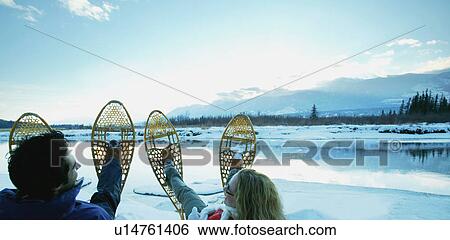 A couple with snowshoes View Large Photo Image Stock Photograph - A couple with snowshoes. Fotosearch