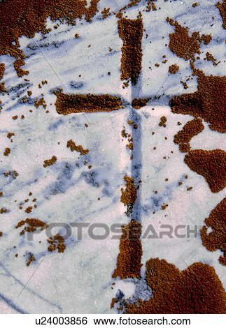 A cross on the ground in the snow and moss View Large Photo Image Stock Photograph - A cross on the ground in the snow and moss. Fotosearch