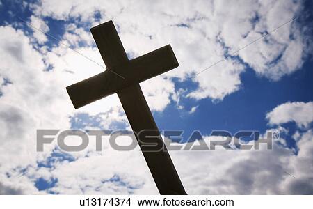 A cross silhouetted against clouds View Large Photo Image Picture - A cross silhouetted against clouds. Fotosearch