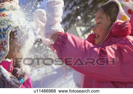 Stock Photo - A fun snowball fight. Fotosearch