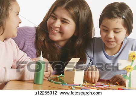 Stock Image - A group doing crafts. Fotosearch