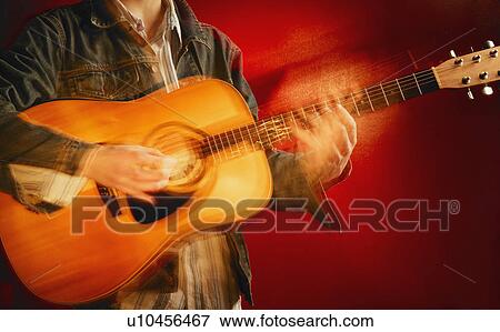 Stock Photo - A guitar player. Fotosearch