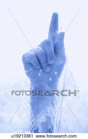 Stock Image - A hand piercing the cold water. Fotosearch