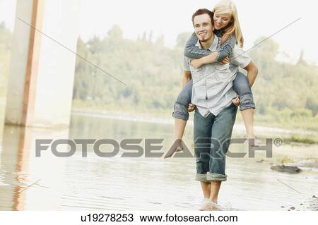 Stock Image - A piggy back ride. Fotosearch