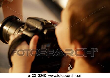 Stock Image - A young photographer. Fotosearch
