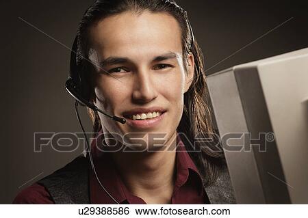 Aboriginal call centre worker View Large Photo Image Stock Photograph - Aboriginal call centre worker. Fotosearch