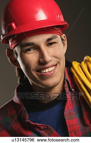 Stock Photograph - Aboriginal Workman wearing a hard hat. Fotosearch