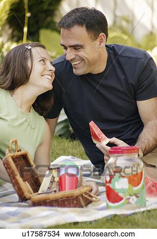 Picture - Adult couple having a picnic. Fotosearch