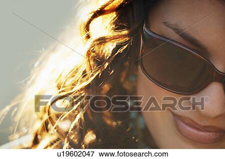 Attractive woman wearing designer sunglasses View Large Photo Image Stock Photo - Attractive woman wearing designer sunglasses. Fotosearch
