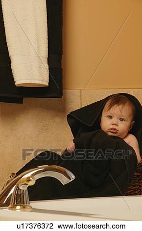 Baby sits wrapped in towel View Large Photo Image Stock Image - Baby sits wrapped in towel. Fotosearch