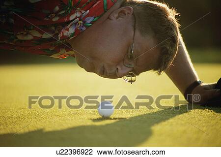 Stock Image - Blowing ball into the hole. Fotosearch