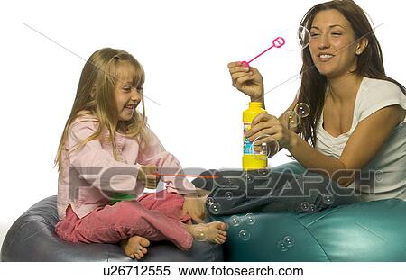 Stock Photography - Blowing bubbles. Fotosearch