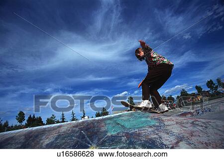 Boarder performing stunt at skate park View Large Photo Image Stock Photo - Boarder performing stunt at skate park. Fotosearch