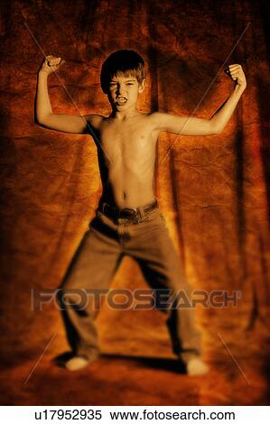 Boy flexing his muscles View Large Photo Image Stock Photography - Boy flexing his muscles. Fotosearch