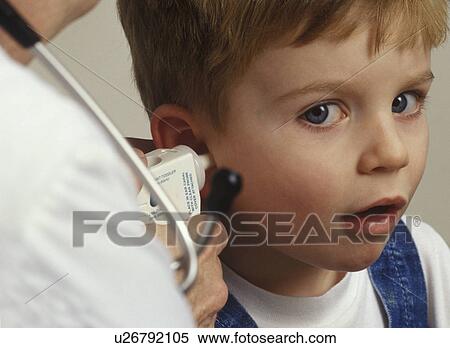 Boy getting ear examined by doctor View Large Photo Image Stock Photography - Boy getting ear examined by doctor. Fotosearch