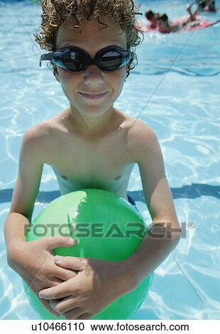 Boy holds ball in pool View Large Photo Image Stock Image - Boy holds ball in pool. Fotosearch