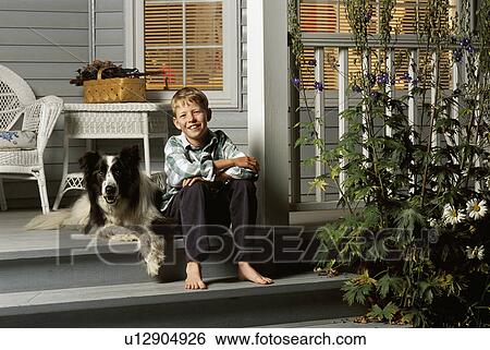 Boy sitting with dog on porch steps View Large Photo Image Stock Photograph - Boy sitting with dog on porch steps. Fotosearch