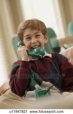Boy talking on the phone View Large Photo Image Stock Image - Boy talking on the phone. Fotosearch