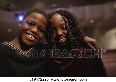 Stock Image - Boy with arm around girl. Fotosearch