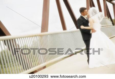 Stock Image - Bride and groom kiss. Fotosearch