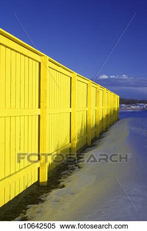 Bright yellow fence with blue sky and snow View Large Photo Image Stock Photography - Bright yellow fence with blue sky and snow. Fotosearch