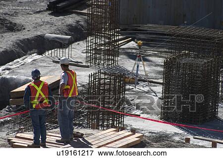 Building site and two construction workers View Large Photo Image Stock Photo - Building site and two construction workers. Fotosearch