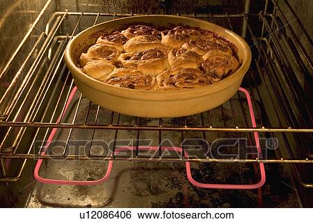Stock Photograph - Buns in the oven. Fotosearch