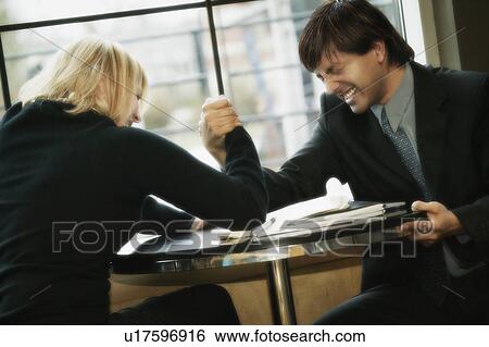 Stock Photograph - Business couple having arm wrestle. Fotosearch