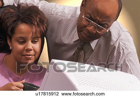 Stock Image - Business People in front of computer monitor. Fotosearch